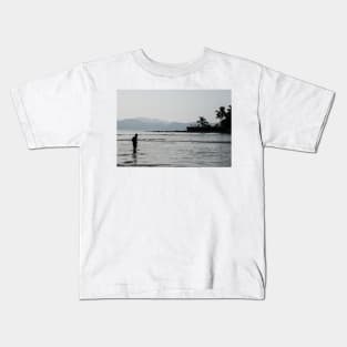 Boy walking through water in low tide Kids T-Shirt